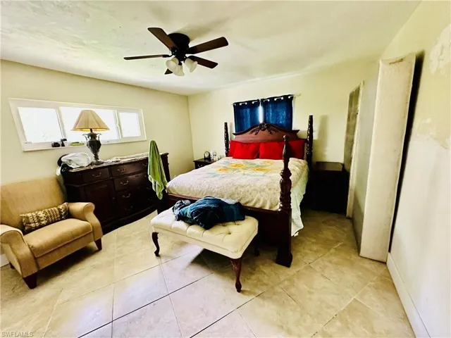 Tiled bedroom with ceiling fan