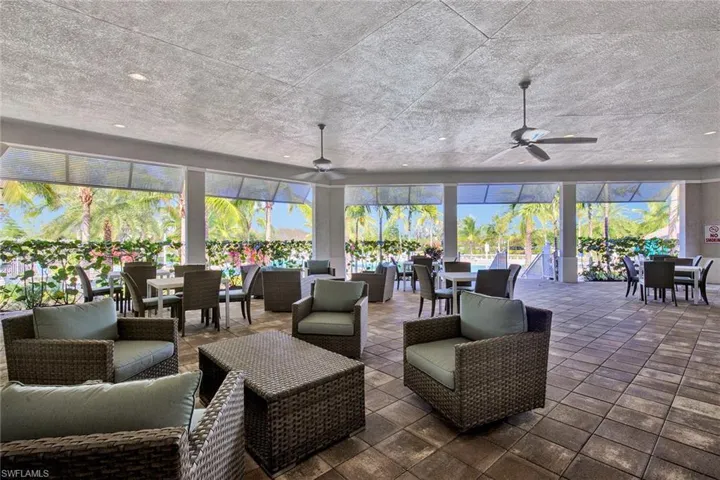 View of patio with outdoor dining space, an outdoor hangout area, a sunroom, and ceiling fan