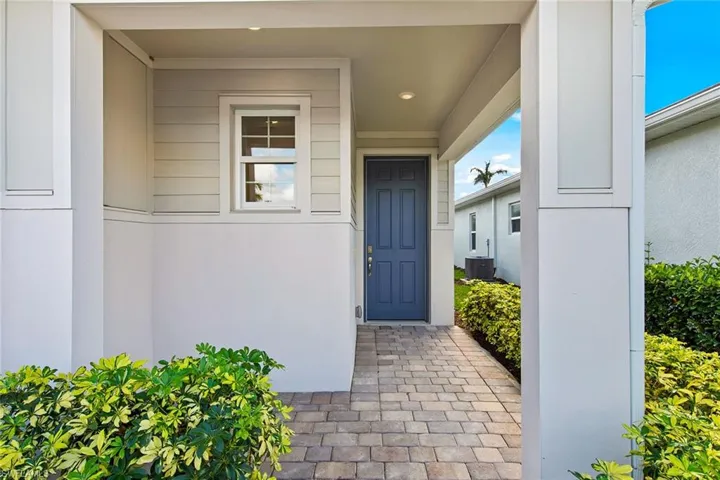 Property entrance featuring stucco siding