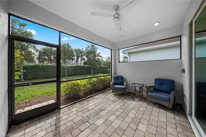 Unfurnished sunroom featuring a ceiling fan