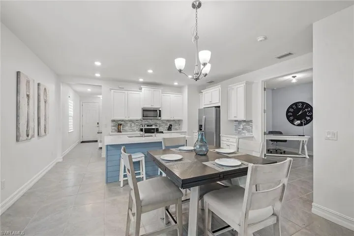 Dining room with recessed lighting, a chandelier, and light tile patterned flooring