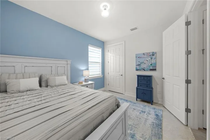 Bedroom with light tile patterned floors and baseboards