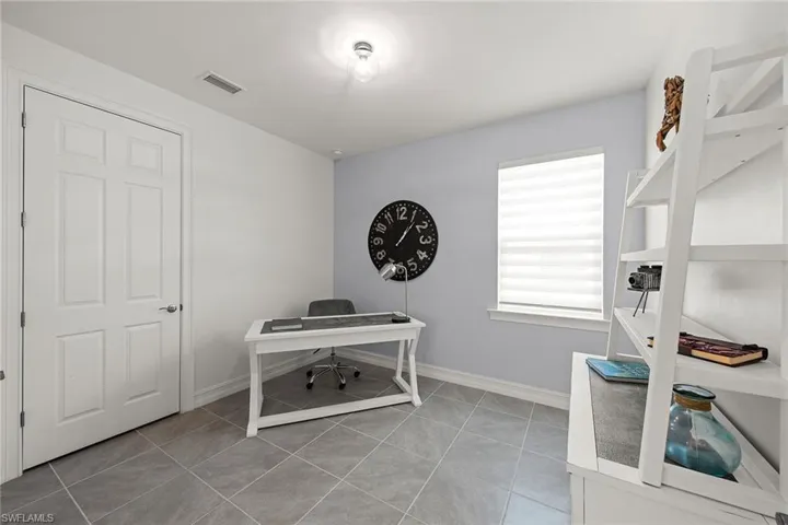 Office area featuring light tile patterned flooring