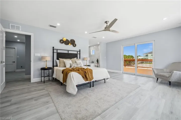 Primary Bedroom with Private Balcony and Walk-In Closet