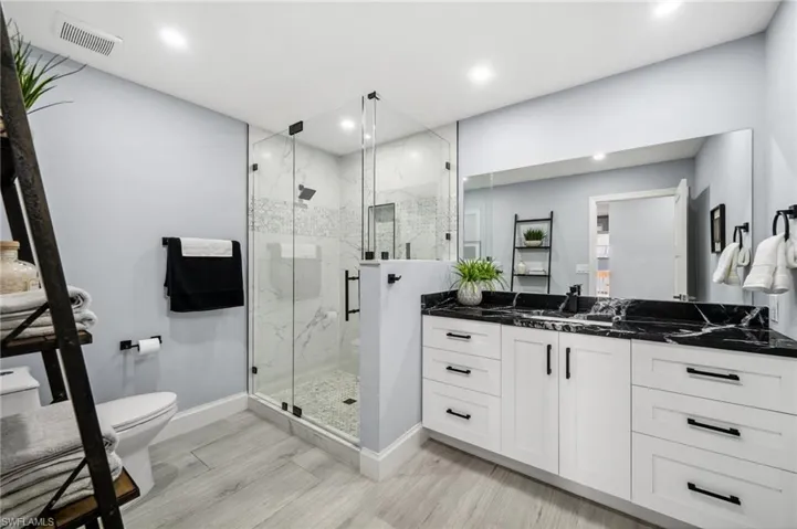 Guest bathroom with tiled, glass-walled shower