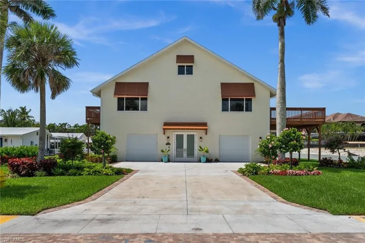Lush tropical landscaping surrounds the property