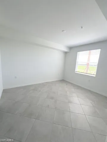 Spare room featuring baseboards
