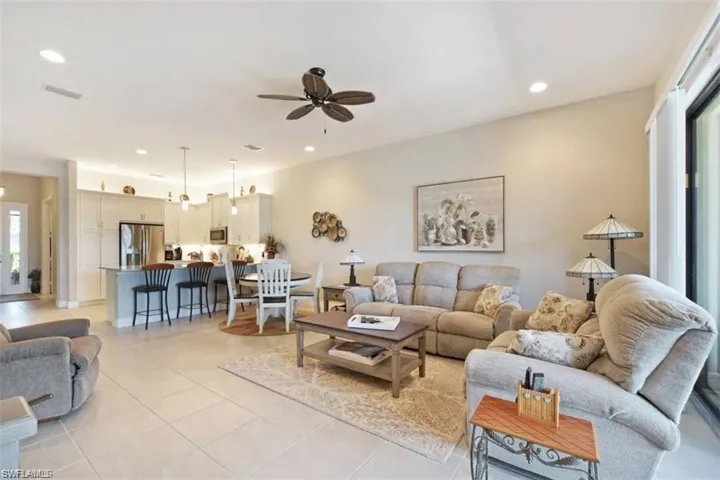 Tiled living room featuring large ceiling fan