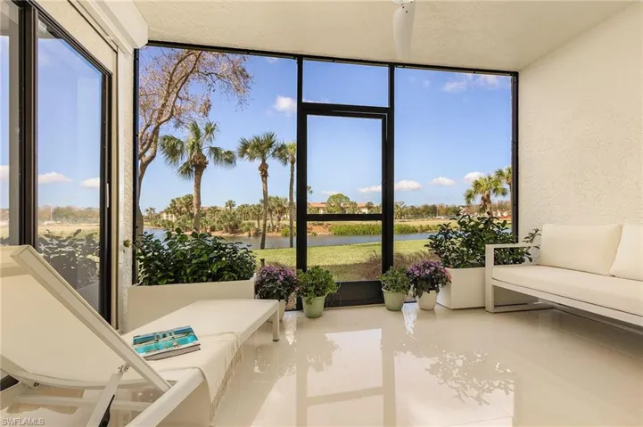 Sunroom featuring a water view