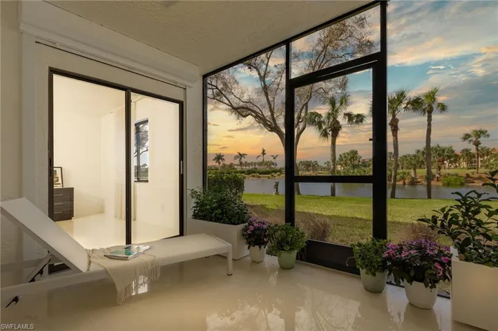 Sunroom with a water view and a healthy amount of sunlight