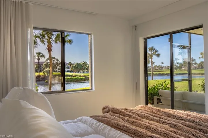 Bedroom featuring multiple windows and a water view