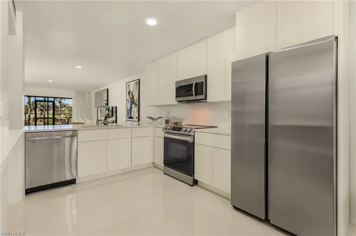 Kitchen with recessed lighting, appliances with stainless steel finishes, white cabinetry, and light countertops