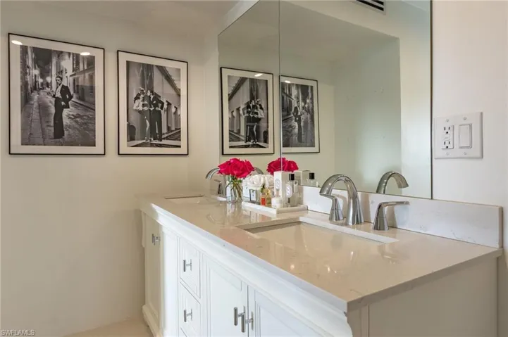 Full bathroom with double vanity and a sink
