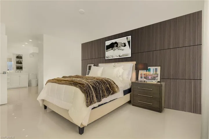 Bedroom featuring light tile patterned floors, recessed lighting, and connected bathroom