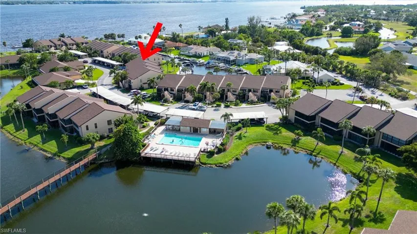 Aerial view of residential area featuring a nearby body of water