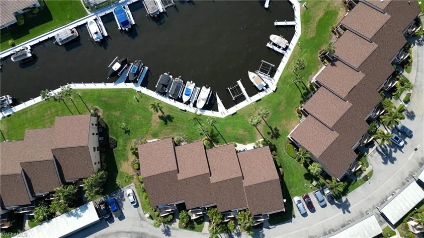 Aerial perspective of suburban area featuring a nearby body of water