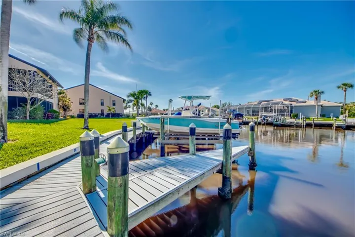 Dock area featuring a water view and a yard