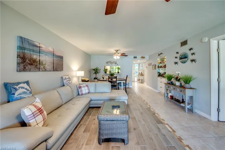 Living area featuring wood finish floors and ceiling fan