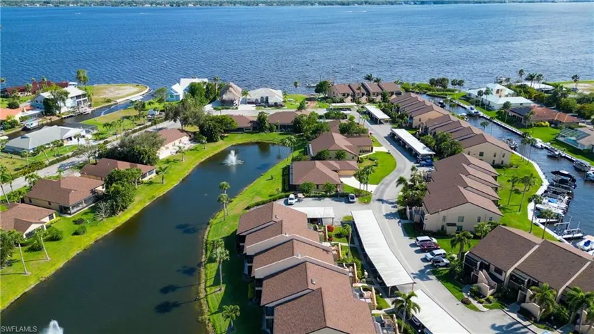 Aerial perspective of suburban area featuring a large body of water