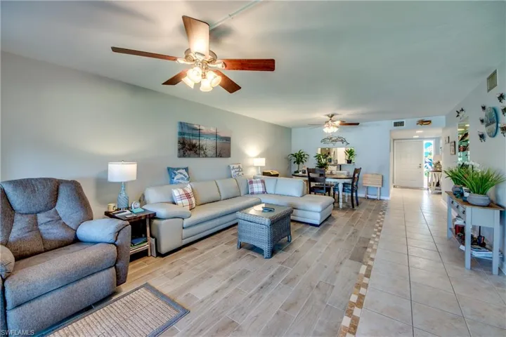 Living area featuring ceiling fan and wood tiled floors