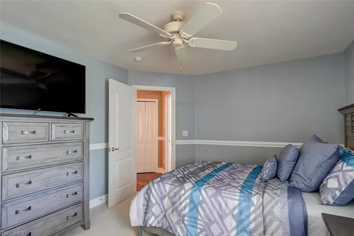Carpeted Guest bedroom featuring ceiling fan
