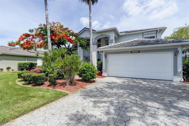 Front facade with a front yard and a garage