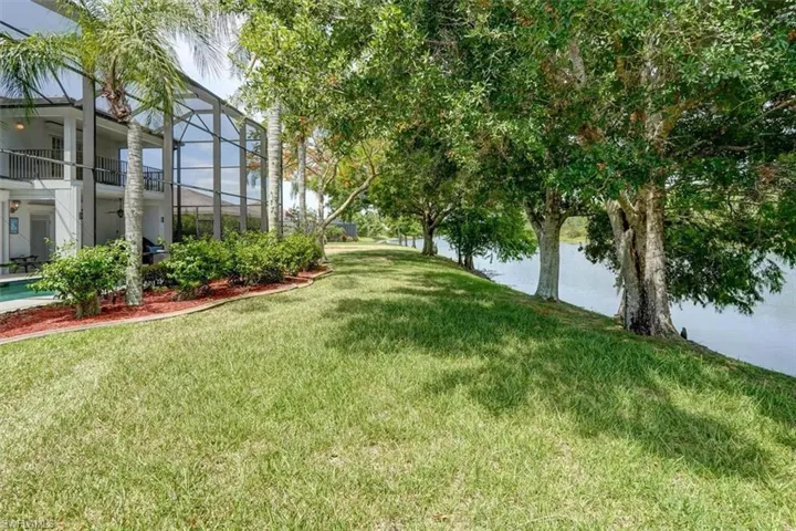 View of yard with a water view and a balcony