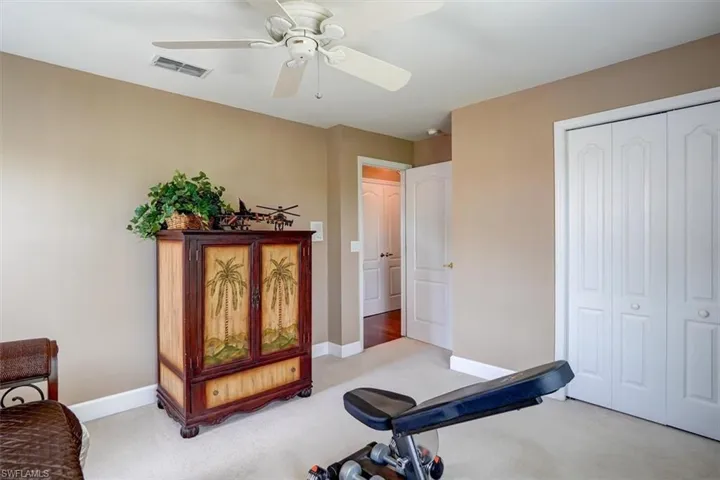 Workout area / Guest Bedroom featuring carpet flooring and ceiling fan