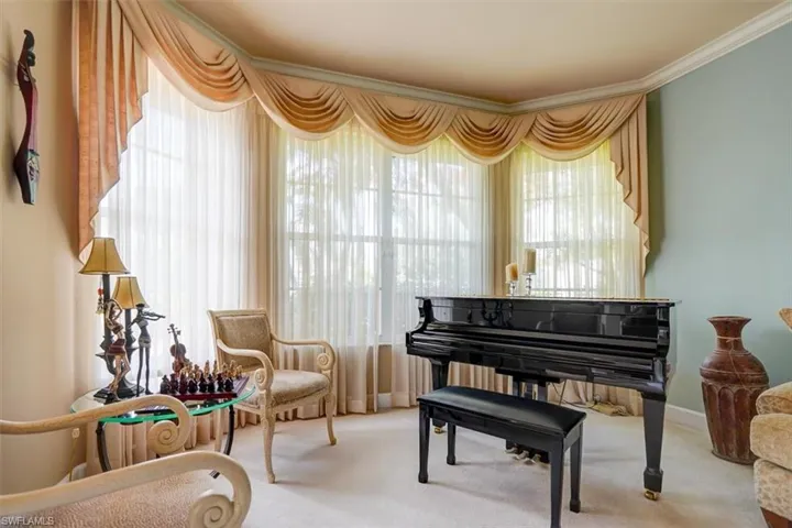 Living area with carpet flooring and ornamental molding