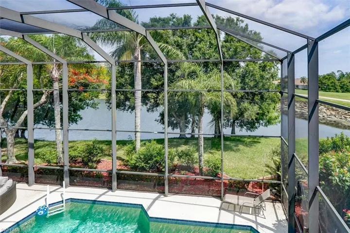View of pool featuring a yard, a lanai, and a patio