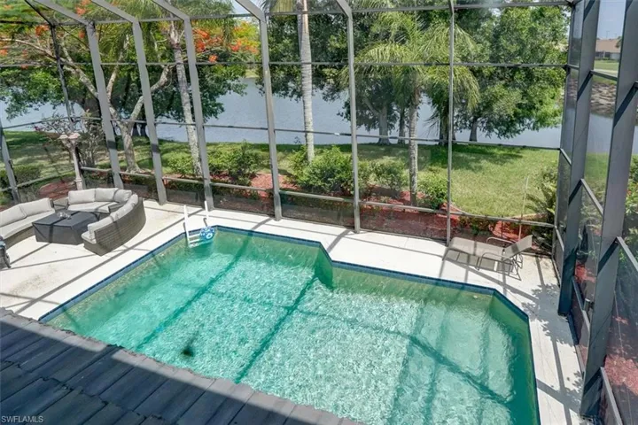 View of swimming pool featuring a lanai and a patio area