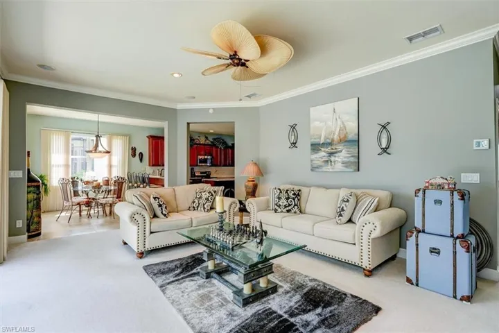 Great Room featuring crown molding, carpet floors, and ceiling fan