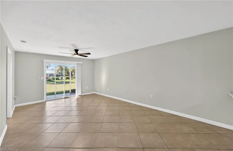 Unfurnished room featuring a ceiling fan and light tile patterned flooring