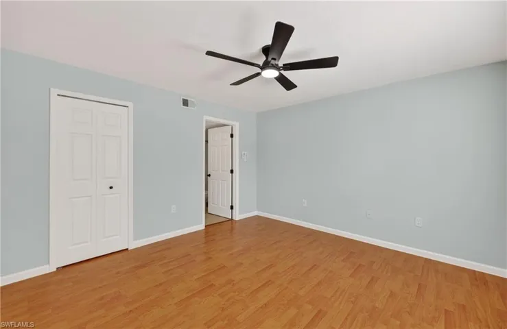 Unfurnished bedroom with a closet, ceiling fan, and light wood finished floors