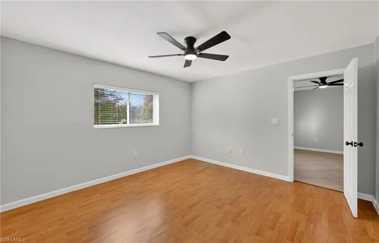 Unfurnished room featuring light wood-style floors and a ceiling fan