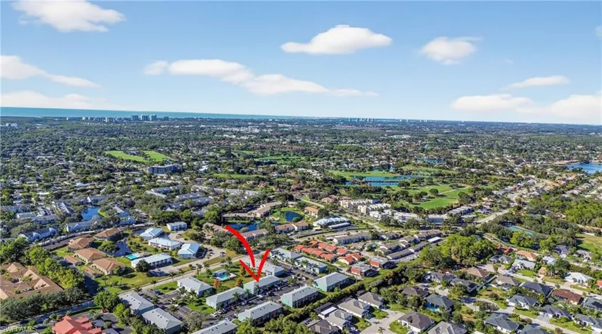 View of property location with a large body of water and nearby suburban area