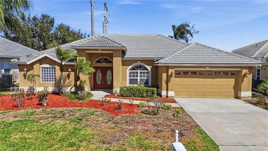 View of front of house featuring stucco siding, an attached garage, driveway, and a tile roof