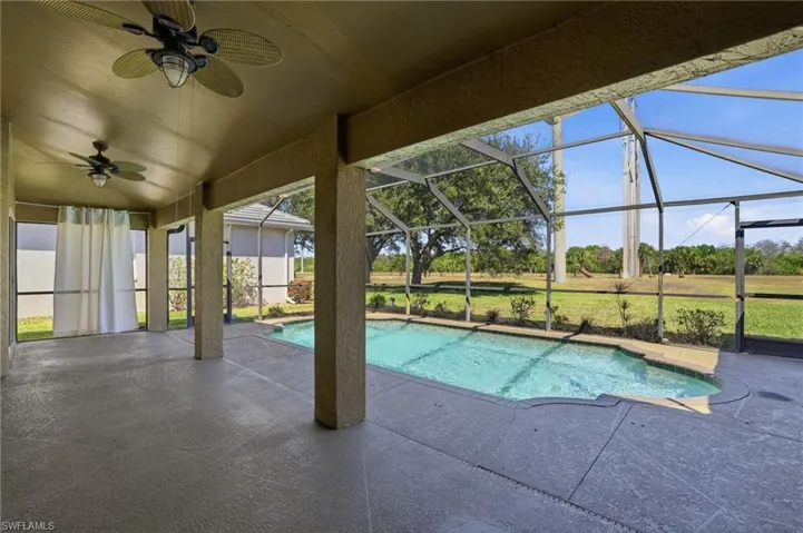 Swimming pool with a sunroom, a patio, and a lanai
