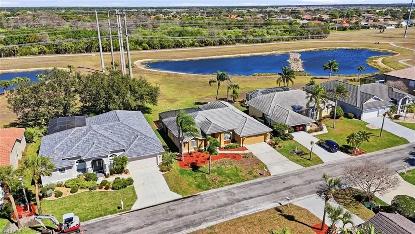 Aerial perspective of suburban area featuring a nearby body of water