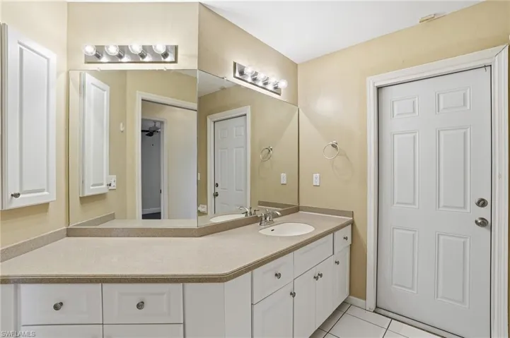 Bathroom featuring vanity and light tile patterned flooring
