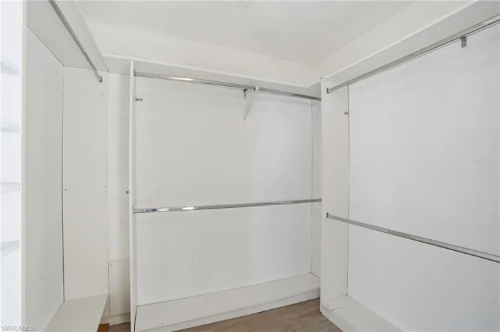 Walk in closet featuring wood finished floors