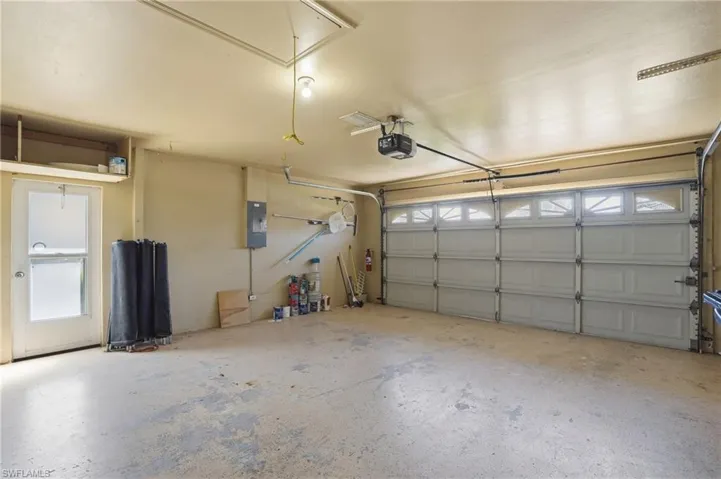 Garage with electric panel and a garage door opener
