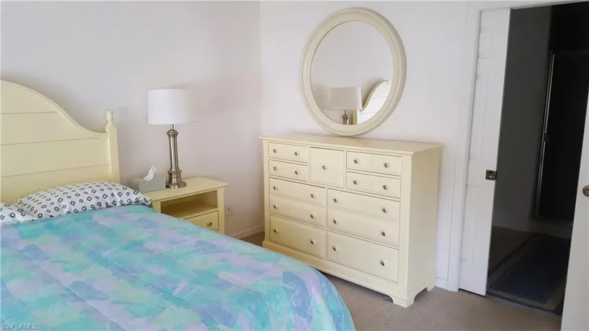 Carpeted bedroom featuring baseboards