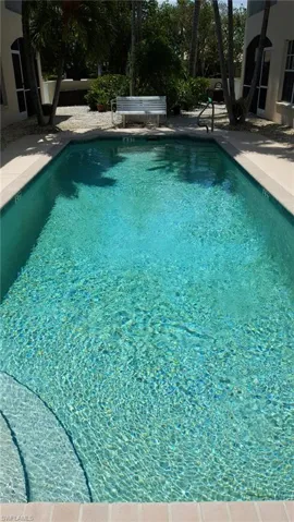 Community pool with a patio