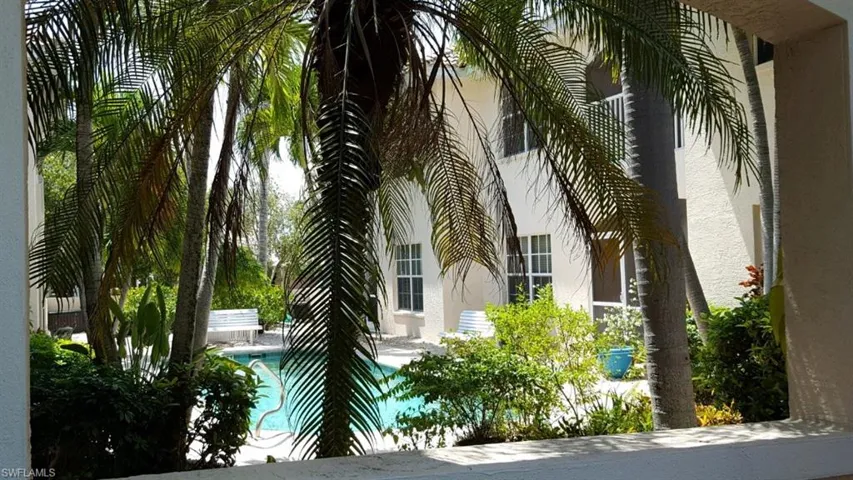 View of side of home featuring stucco siding, an outdoor pool, and a patio
