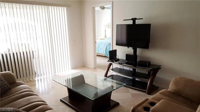 Living room featuring light floors and baseboards