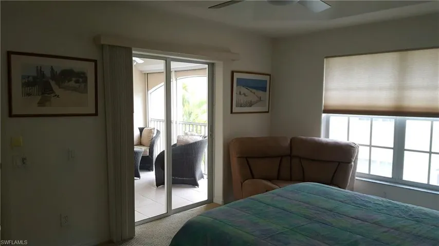 Bedroom with access to outside, baseboards, carpet floors, and a ceiling fan