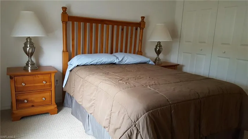 Bedroom featuring light carpet and a closet