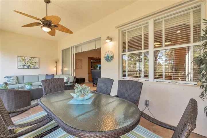 View of patio with outdoor dining area, an outdoor hangout area, and a ceiling fan