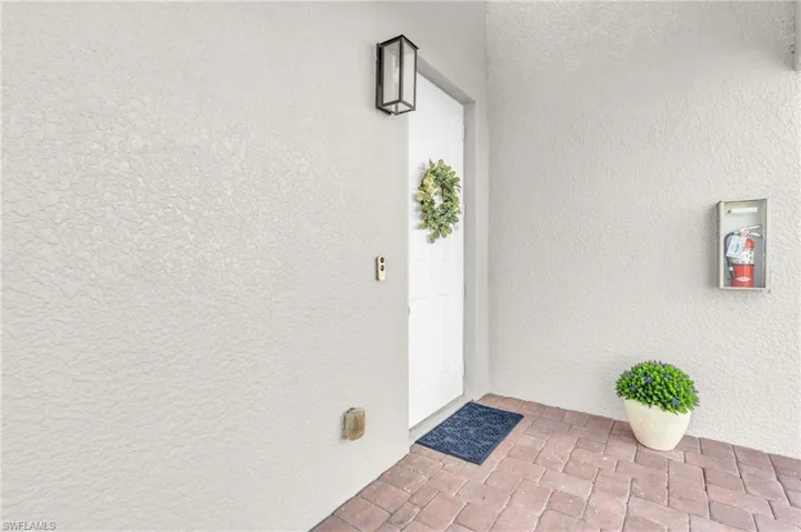 Entrance to property with stucco siding